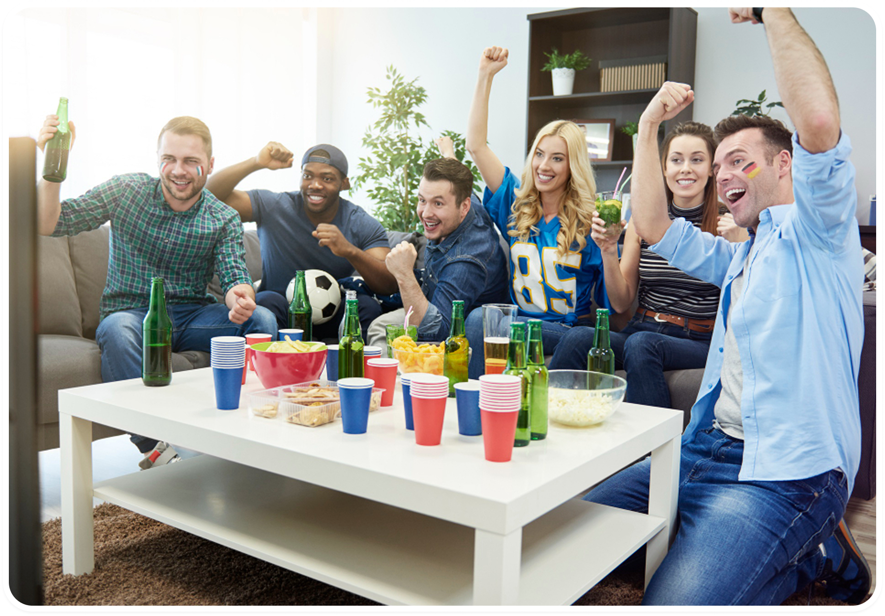 Friends cheering together while watching a game